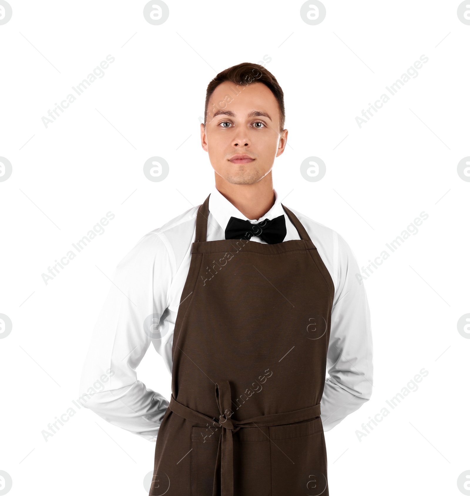 Photo of Portrait of young waiter in uniform on white background