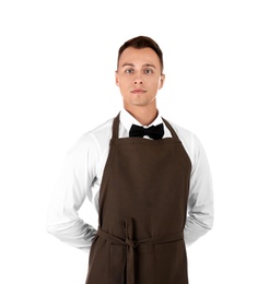 Portrait of young waiter in uniform on white background