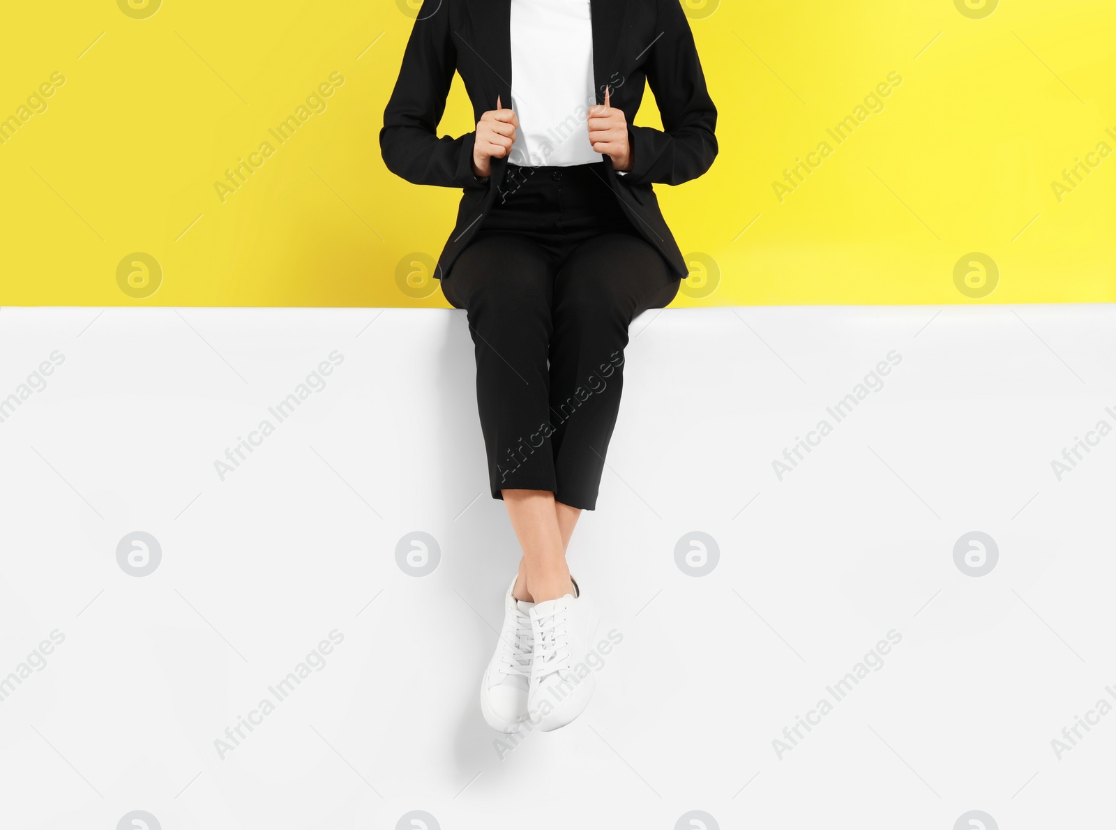 Photo of Woman wearing stylish shoes on color background, closeup