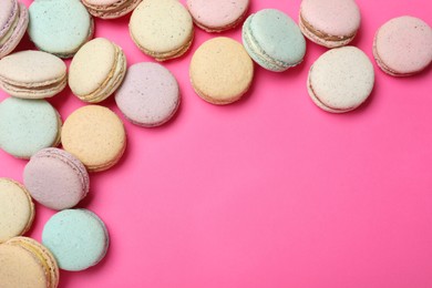 Photo of Delicious colorful macarons on pink background, flat lay. Space for text