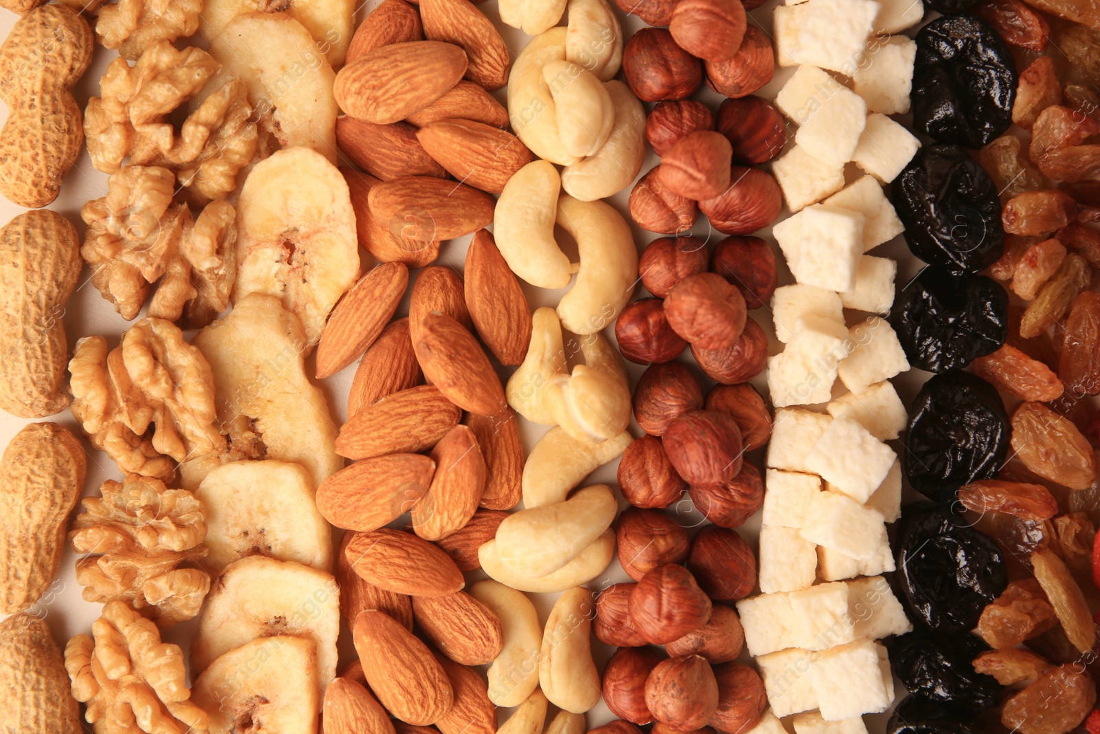 Photo of Different tasty nuts and dried fruits as background, top view