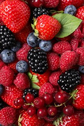 Photo of Different fresh ripe berries as background, top view