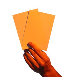 Photo of Man holding orange flyers on white background, closeup. Mockup for design