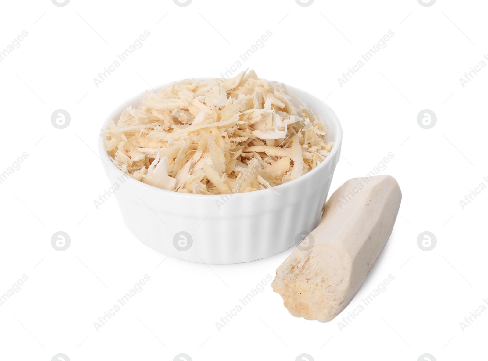 Photo of Grated horseradish in bowl and peeled root isolated on white