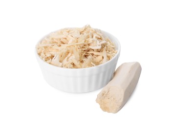 Grated horseradish in bowl and peeled root isolated on white