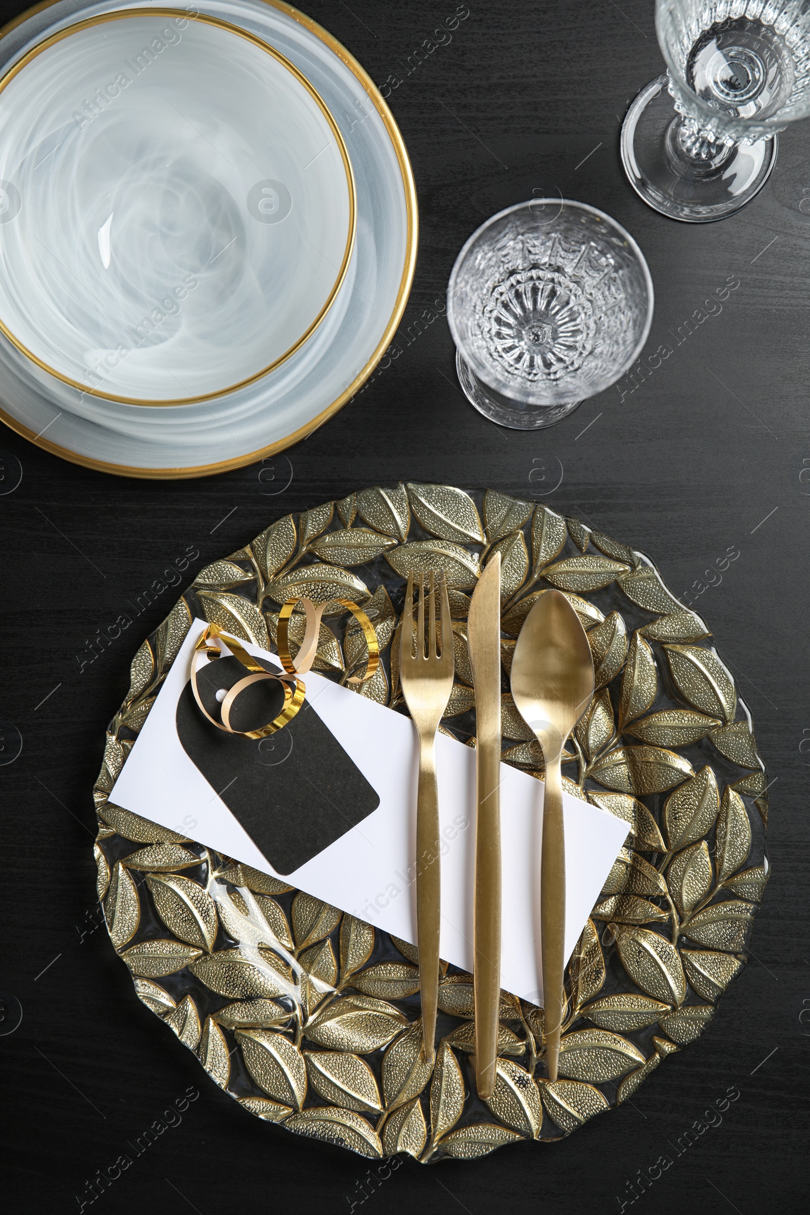 Photo of Elegant table setting on dark background, top view