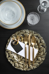 Elegant table setting on dark background, top view