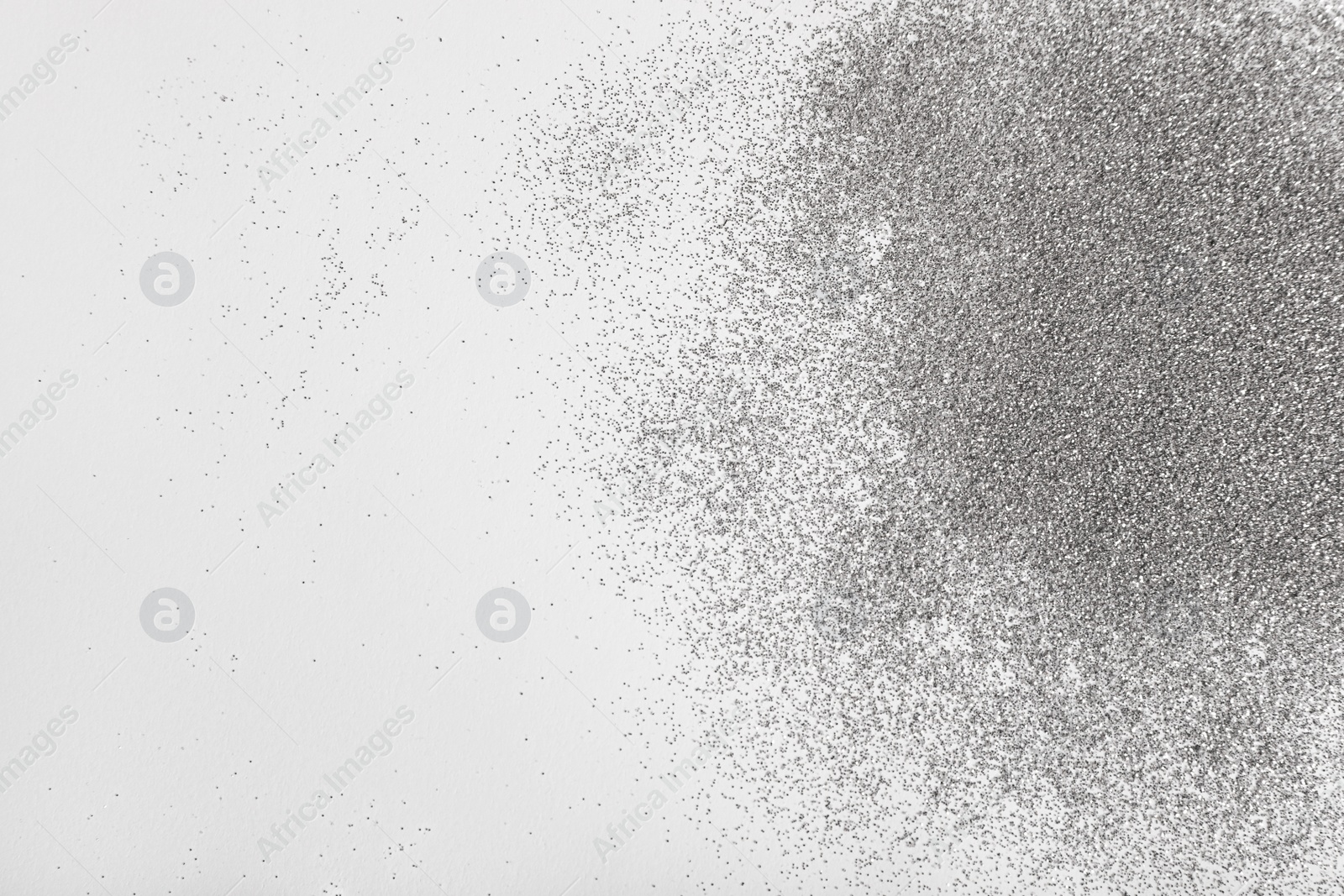 Photo of Shiny silver glitter on white background, top view