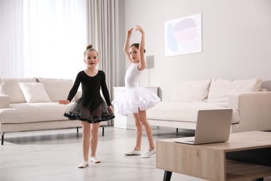 Photo of Cute little girls taking online dance class at home