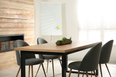 Photo of Modern meeting room interior with large table and chairs