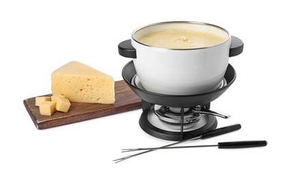 Photo of Fondue with tasty melted cheese, forks and pieces isolated on white