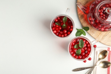 Photo of Tasty hot cranberry tea and fresh ingredients on light table, flat lay. Space for text