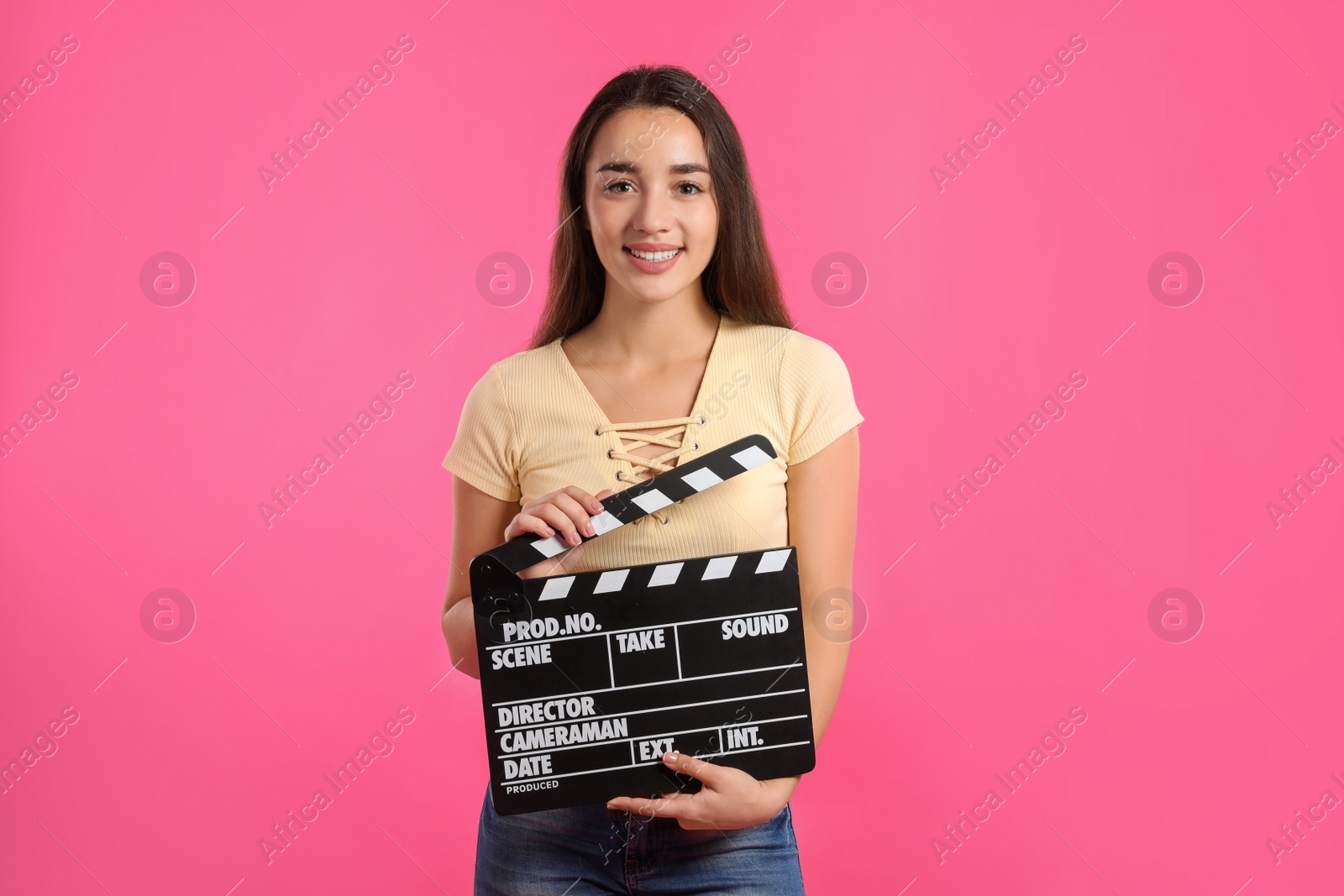 Photo of Woman with clapperboard on color background. Cinema show