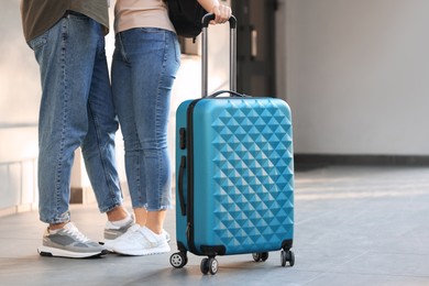 Photo of Long-distance relationship. Couple with luggage near house entrance outdoors, closeup