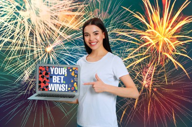 Image of Your Bet Wins! Happy woman pointing at laptop against background with fireworks