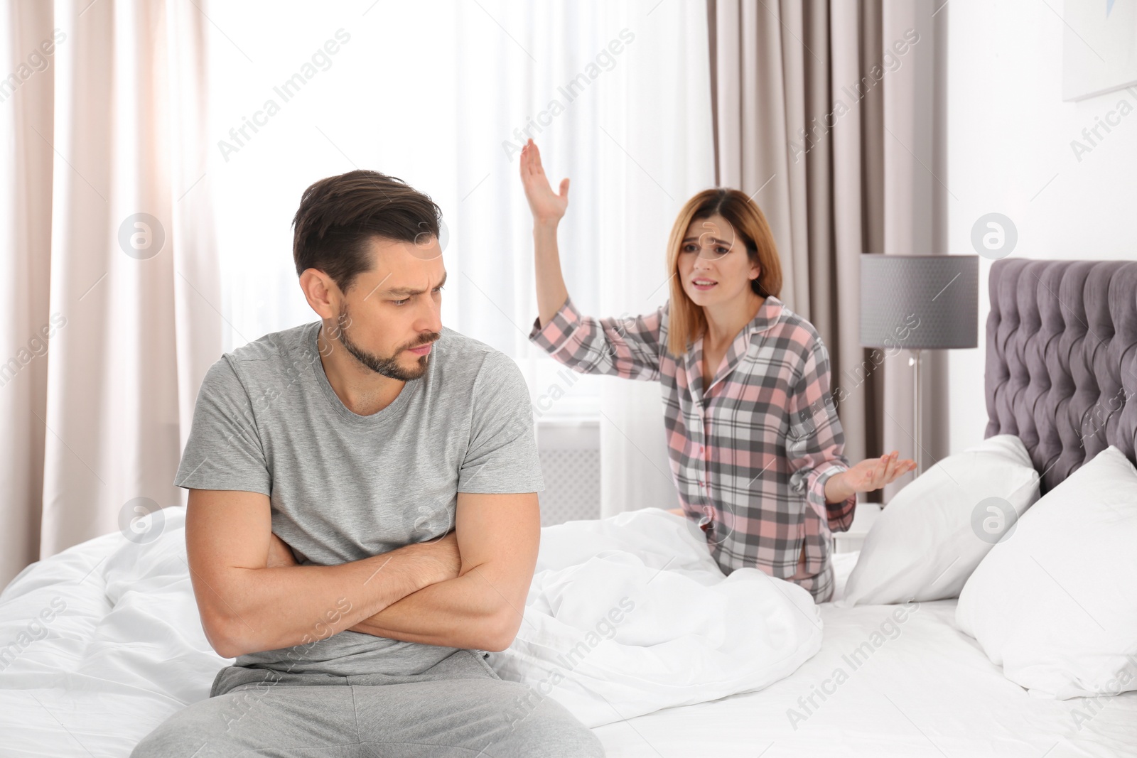 Photo of Couple having argument in bedroom. Relationship problems