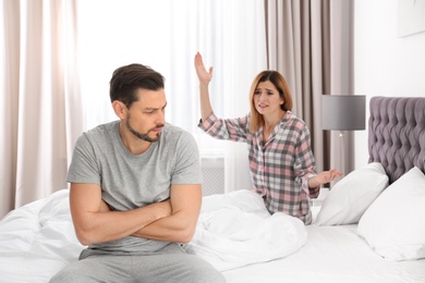 Photo of Couple having argument in bedroom. Relationship problems