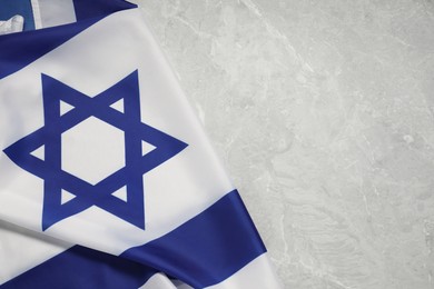 Photo of Flag of Israel on grey marble background, top view and space for text. National symbol