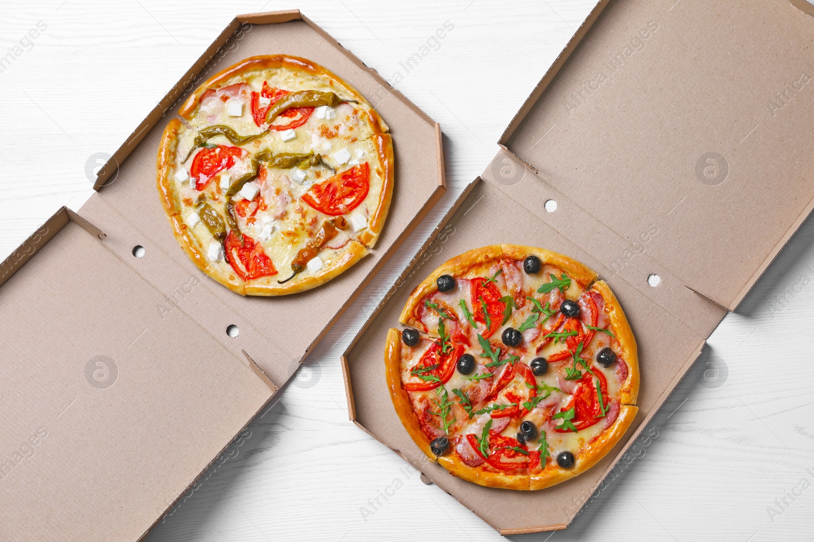 Photo of Cardboard boxes with tasty pizzas on wooden background, top view