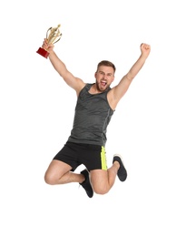 Photo of Excited young sportsman with gold trophy cup jumping on white background