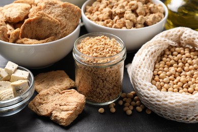 Photo of Different organic soy products on black table