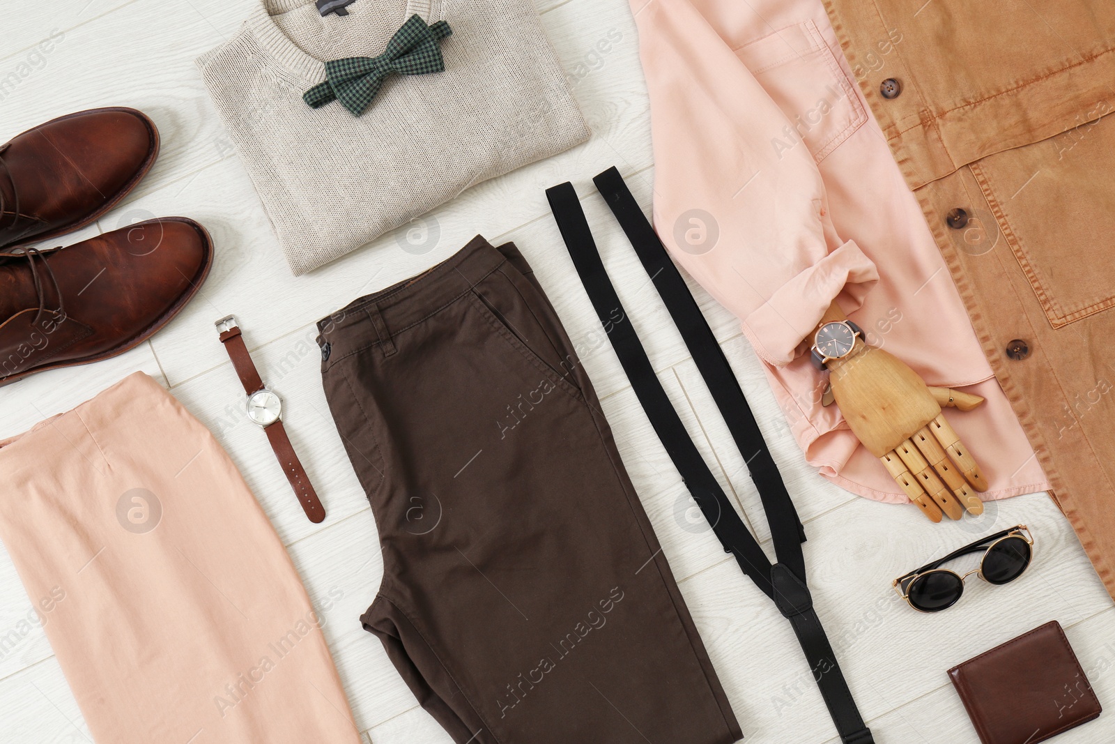 Photo of Flat lay set of stylish clothes and accessories on wooden floor