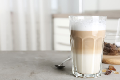 Delicious latte macchiato on grey table indoors, space for text