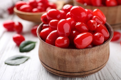 Fresh ripe goji berries in bowl on white wooden table