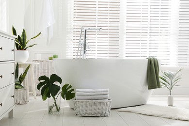 Photo of Stylish bathroom interior with green plants. Home design