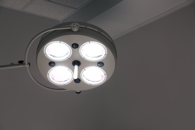 Powerful surgical lamps in modern operating room. Space for text