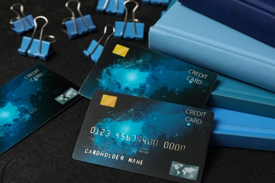 Credit cards and stationery on black background, closeup