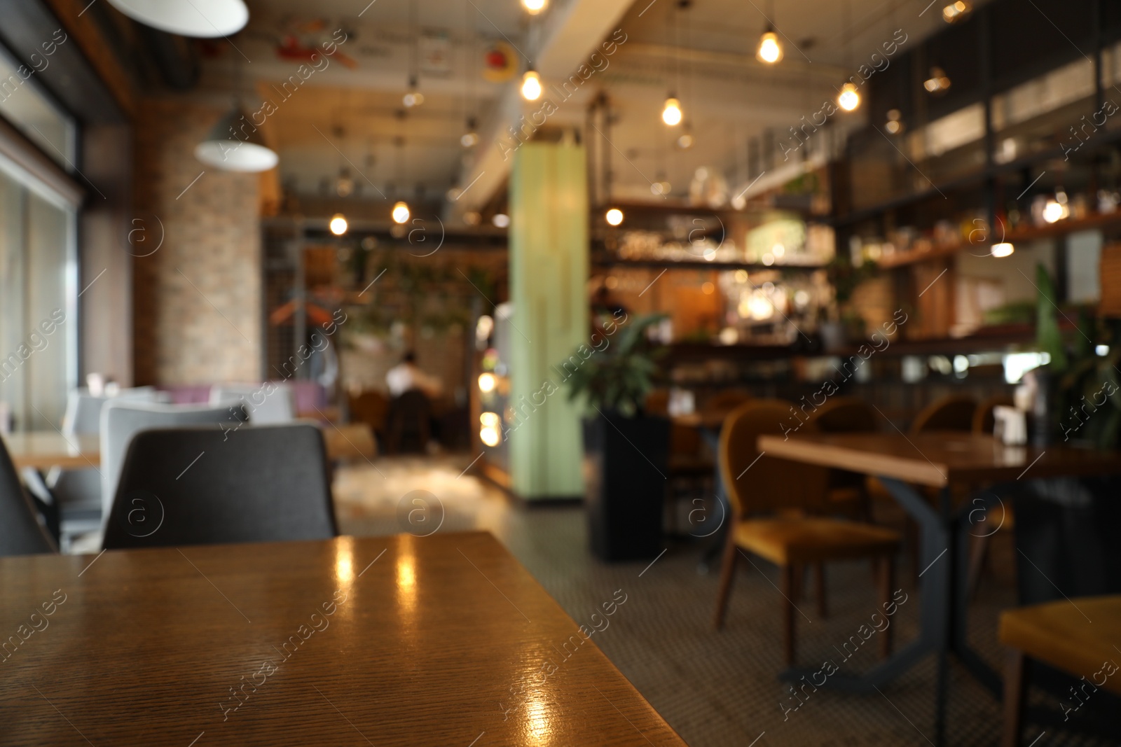 Photo of Blurred view of stylish modern cafe interior with bokeh effect