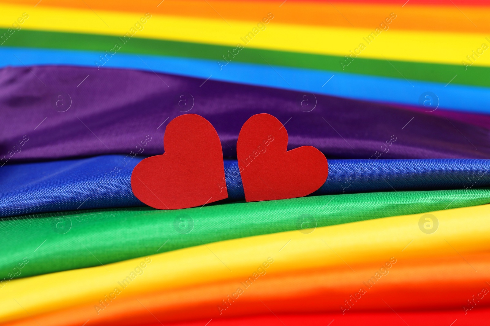 Photo of Hearts on rainbow LGBT flag, closeup view