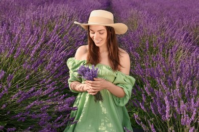 Photo of Smiling woman with bouquet in lavender field
