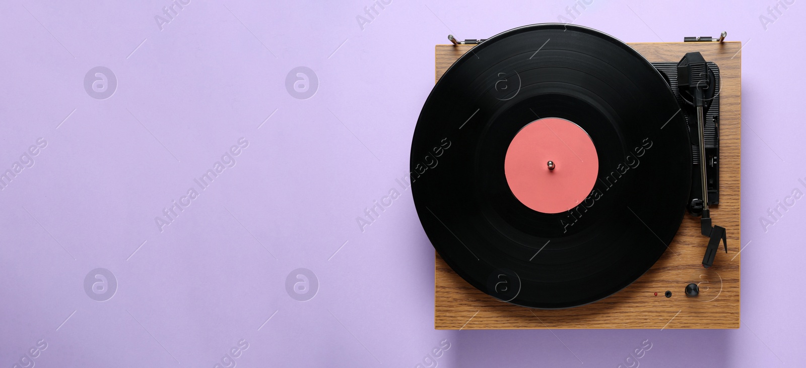 Photo of Modern turntable with vinyl record on light background, top view