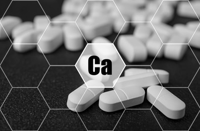 Image of Calcium supplement pills on black background, closeup