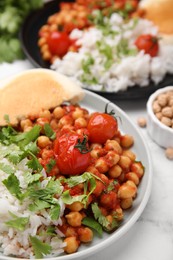 Photo of Plate with delicious chickpea curry on table, closeup