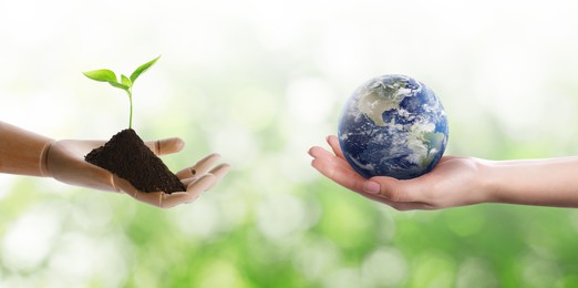 Make Earth green. Woman holding globe, soil with seedling in wooden hand model against blurred background