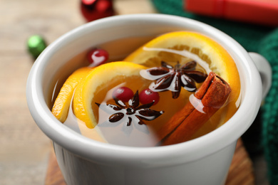 Photo of Delicious aromatic mulled wine on table, closeup