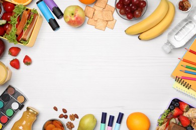 Photo of Frame of lunch boxes with healthy food and stationery on white wooden table, flat lay. Space for text