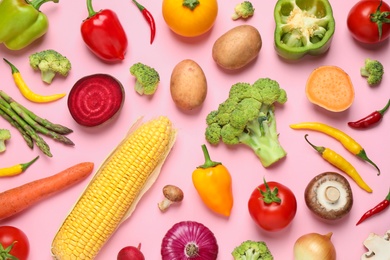 Photo of Flat lay composition with fresh vegetables on pink background