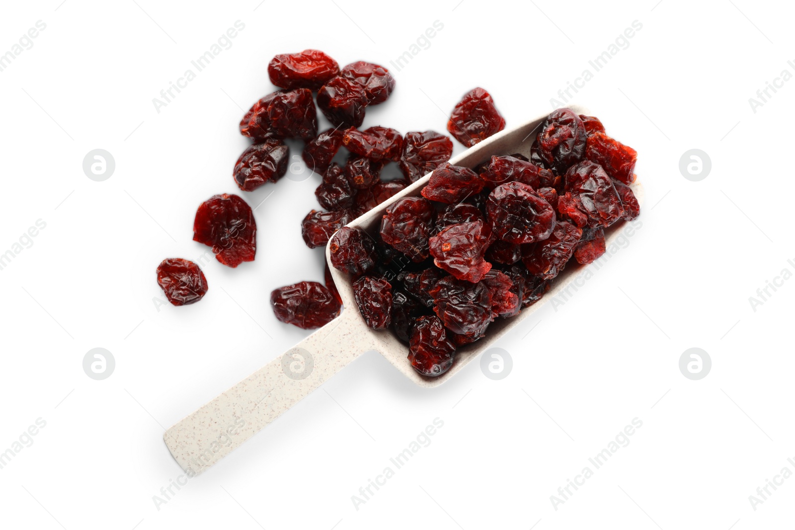 Photo of Tasty dried cranberries and scoop isolated on white, top view