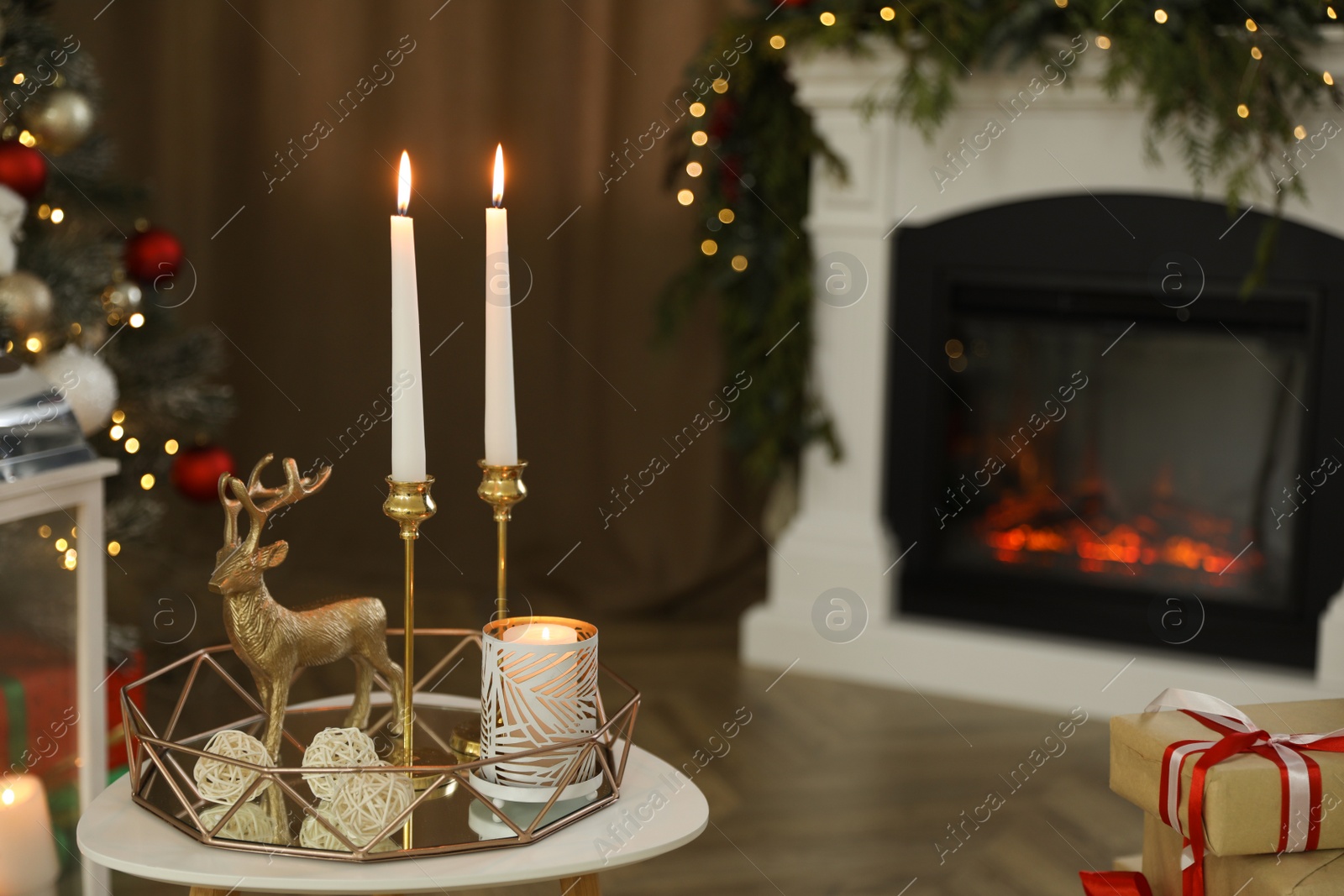 Photo of Beautiful Christmas composition with burning candles on table indoors