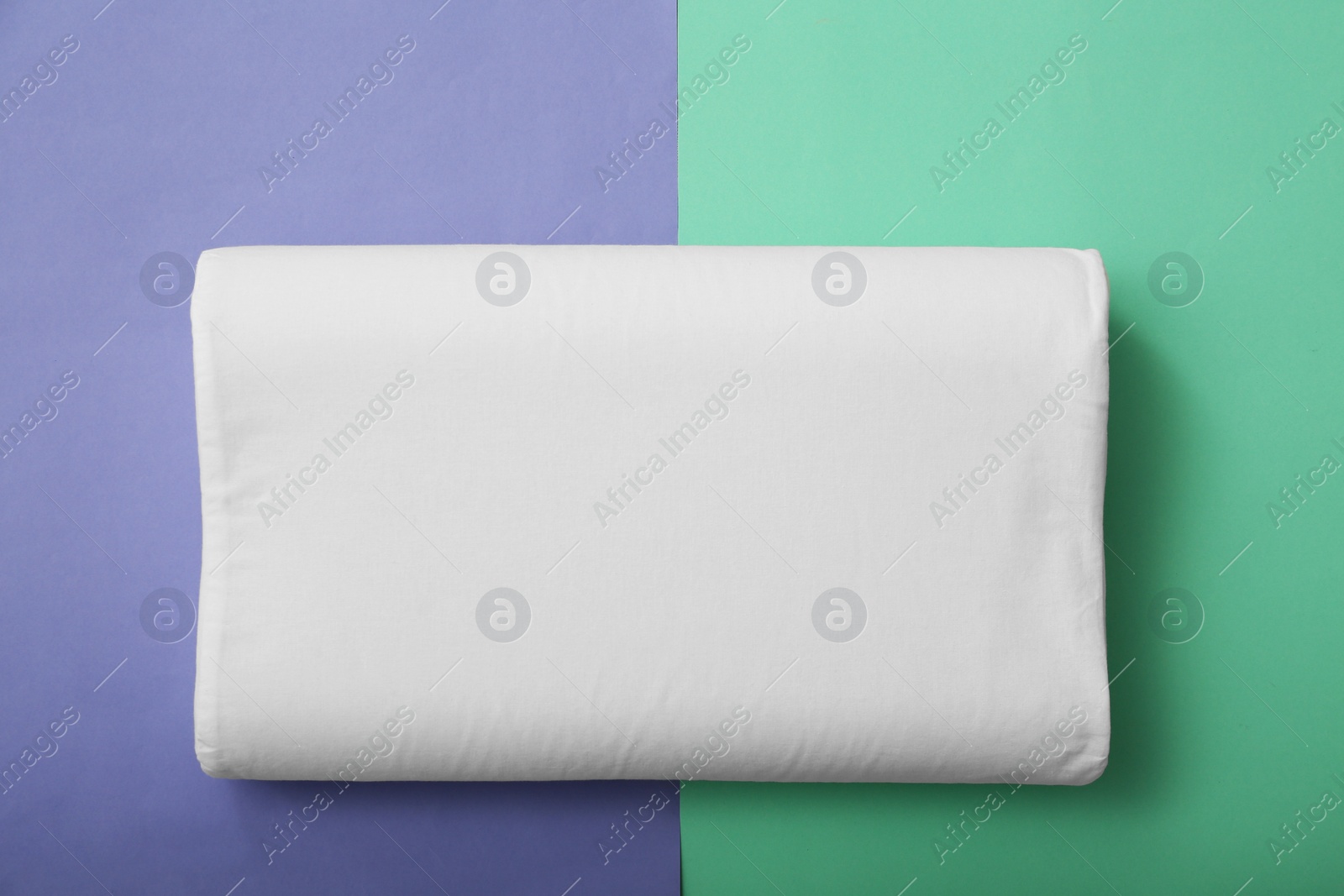 Photo of Soft bed pillow on color background, top view