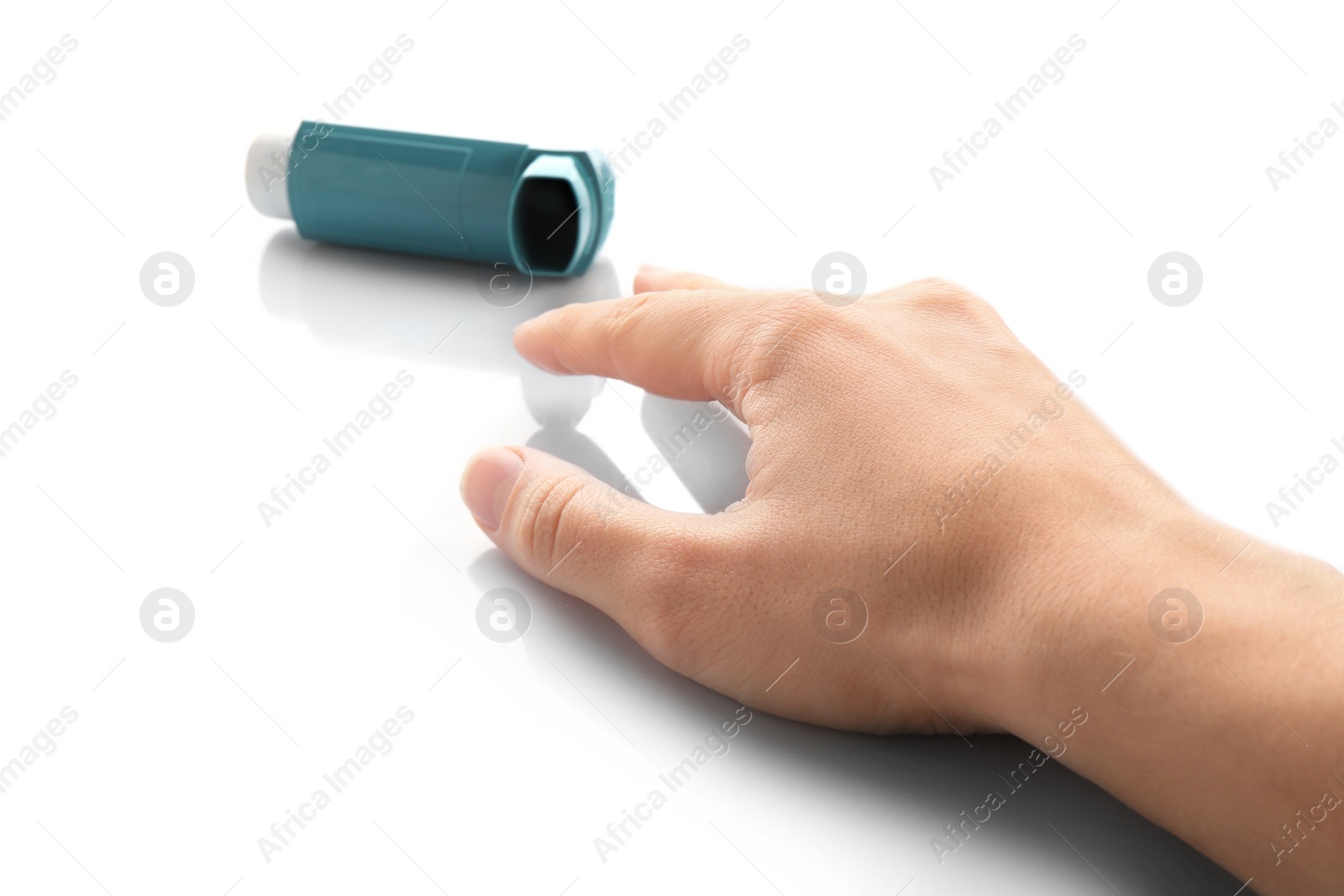 Photo of Woman reaching for asthma inhaler on white background