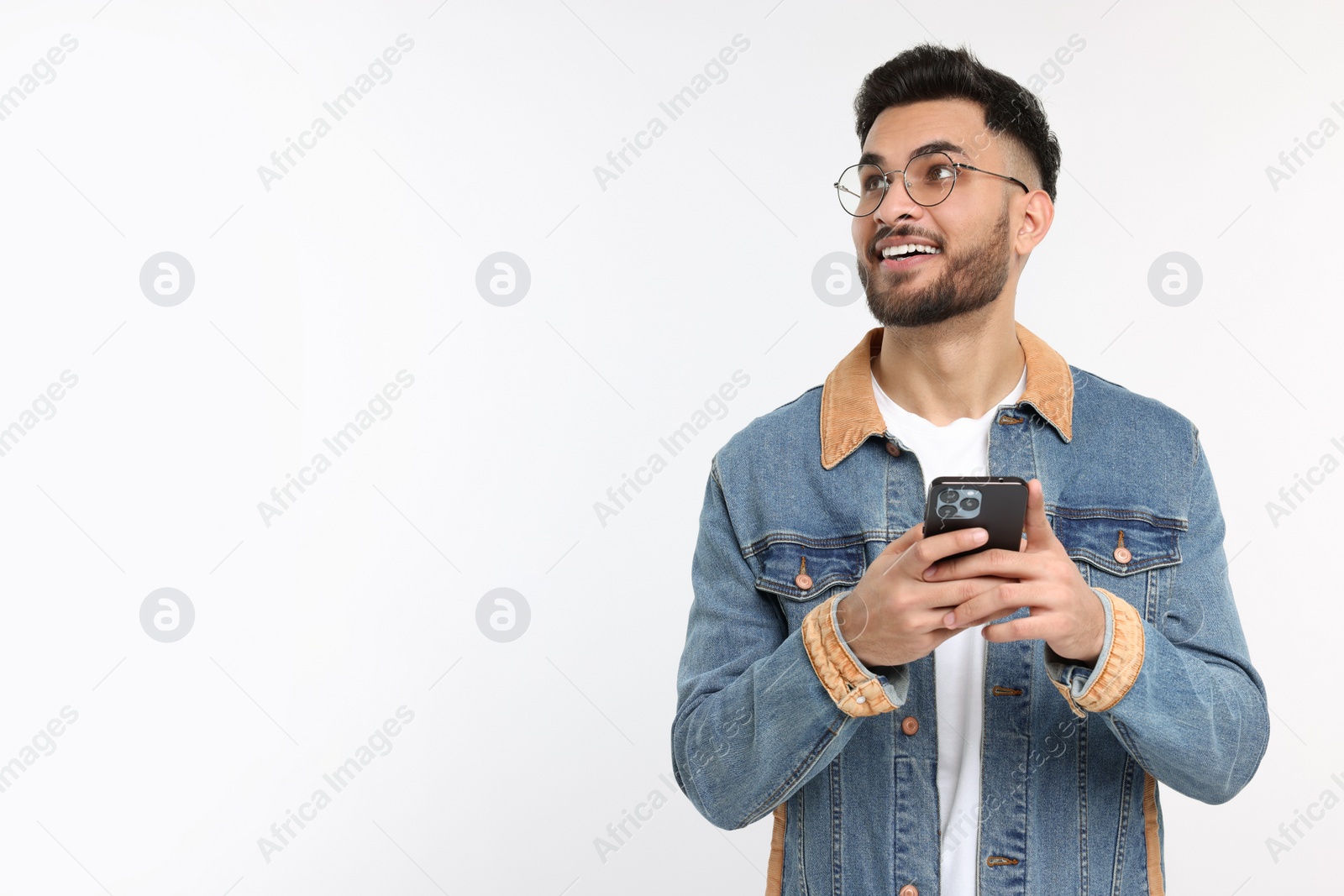 Photo of Happy young man using smartphone on white background, space for text
