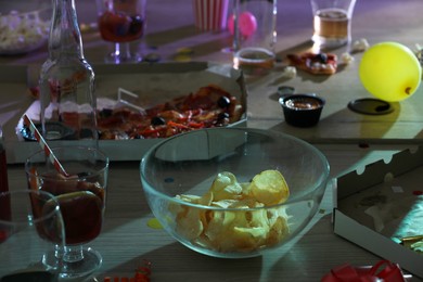 View of messy table with drinks and leftovers after party