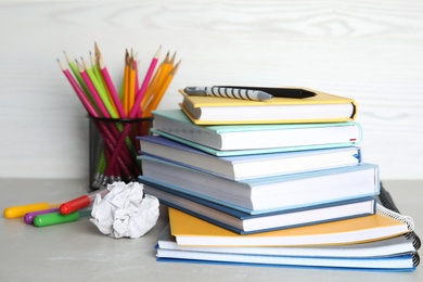 Photo of Different school stationery on table against light background