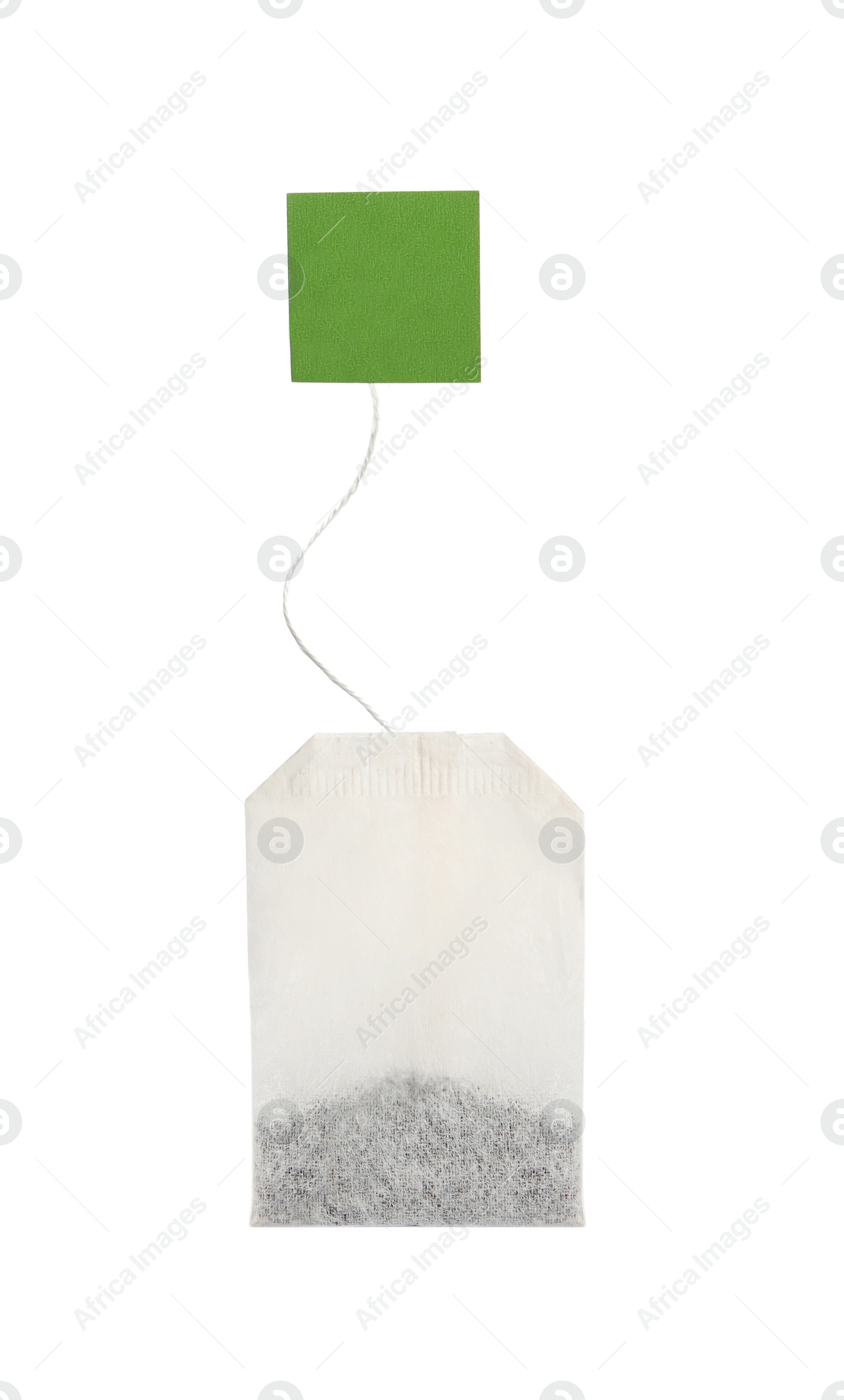Photo of Paper tea bag with tag isolated on white