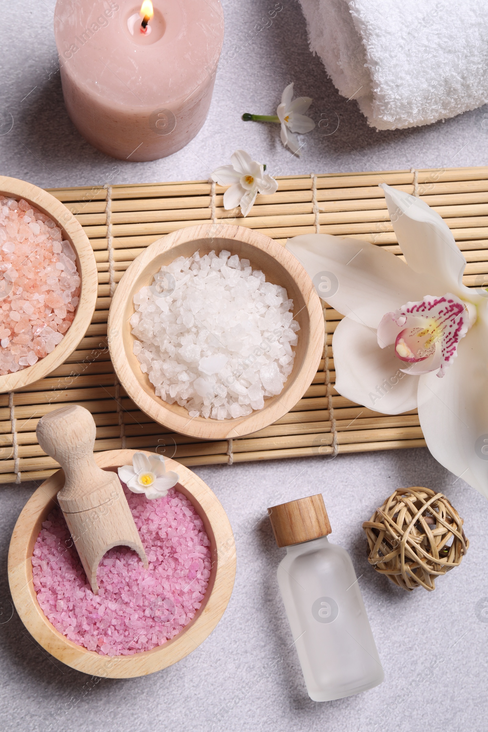 Photo of Flat lay composition with different spa products and orchid on light grey table